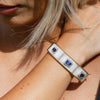 Triple Tanzanite Gold Bangle with Diamonds in Mother of Pearl